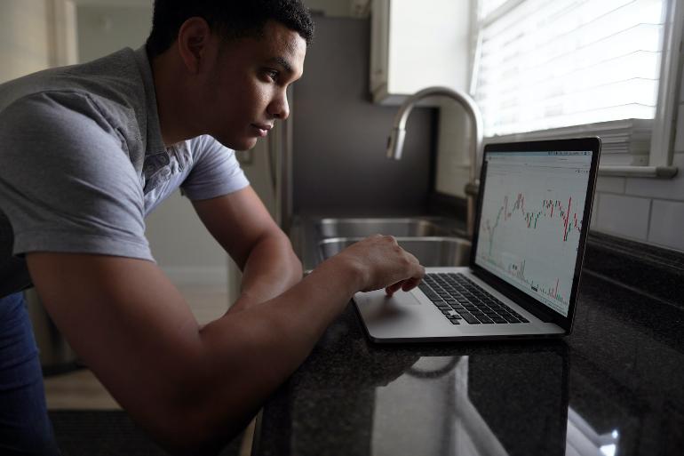 Odoo Demand Forecasting man in gray t-shirt using macbook pro